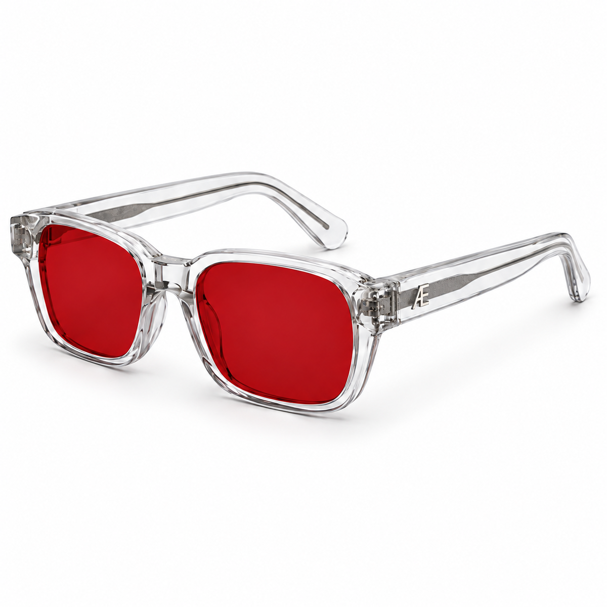ATÉN Crystal Clear frame with deep red After Hours lenses, open three-quarter view, silver cores and monogram on white background.