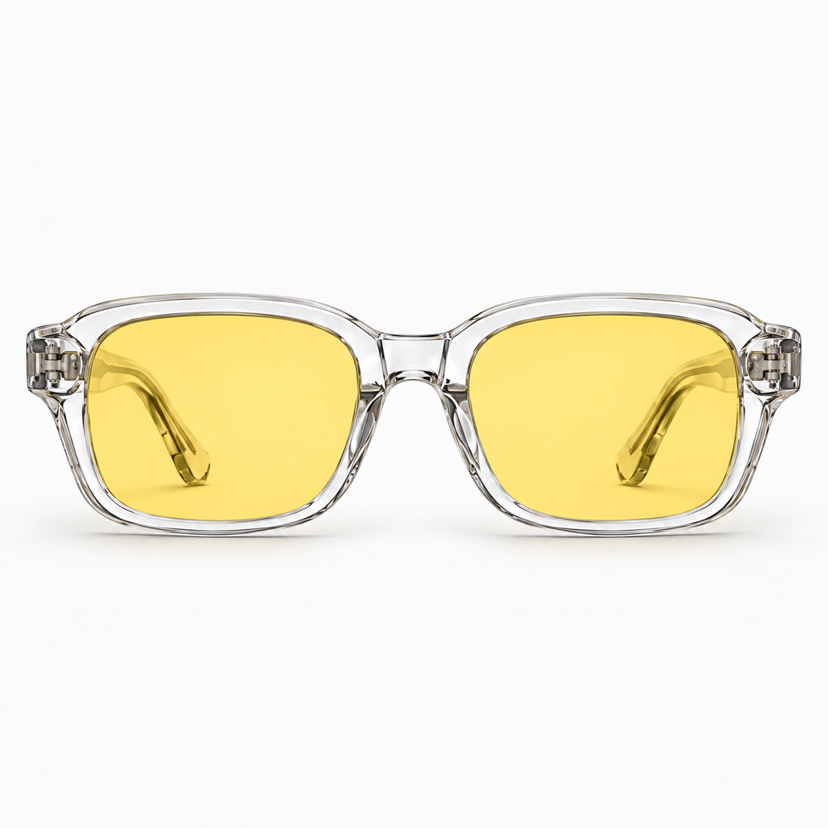 Front view of ATÉN Crystal Clear frame with pronounced amber Focus Mode lenses, silver hinges and visible temple tips on white background.