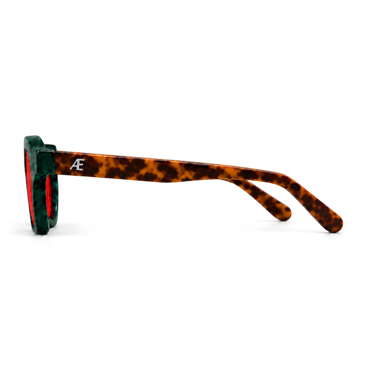 Left-side profile of ATÉN Forest/Tortoise glasses with a deep red After Hours lens; deep forest-green rim, brown tortoiseshell temples and silver ATÉN monogram, isolated with soft natural shadows.