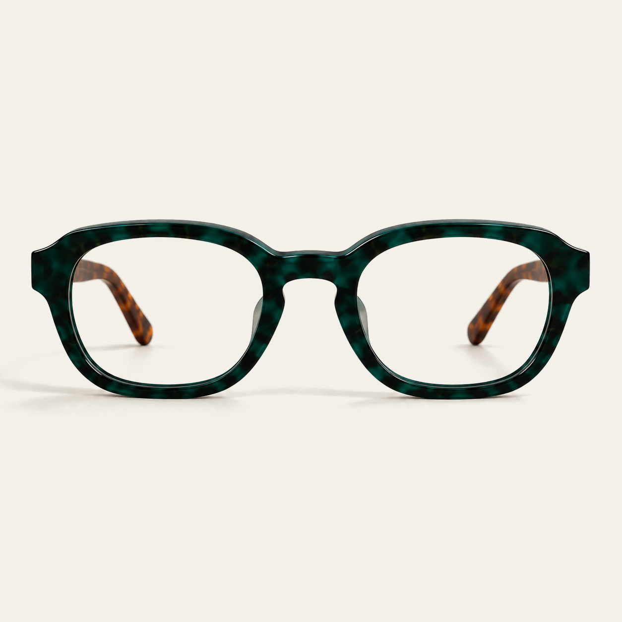 Straight-on front view of ATÉN Forest/Tortoise glasses with Everyday Mode lenses; the deep forest-green marbled front is centred, brown tortoiseshell temple tips are visible through the lenses, and a soft shadow rests beneath the lower rims on the cream background.